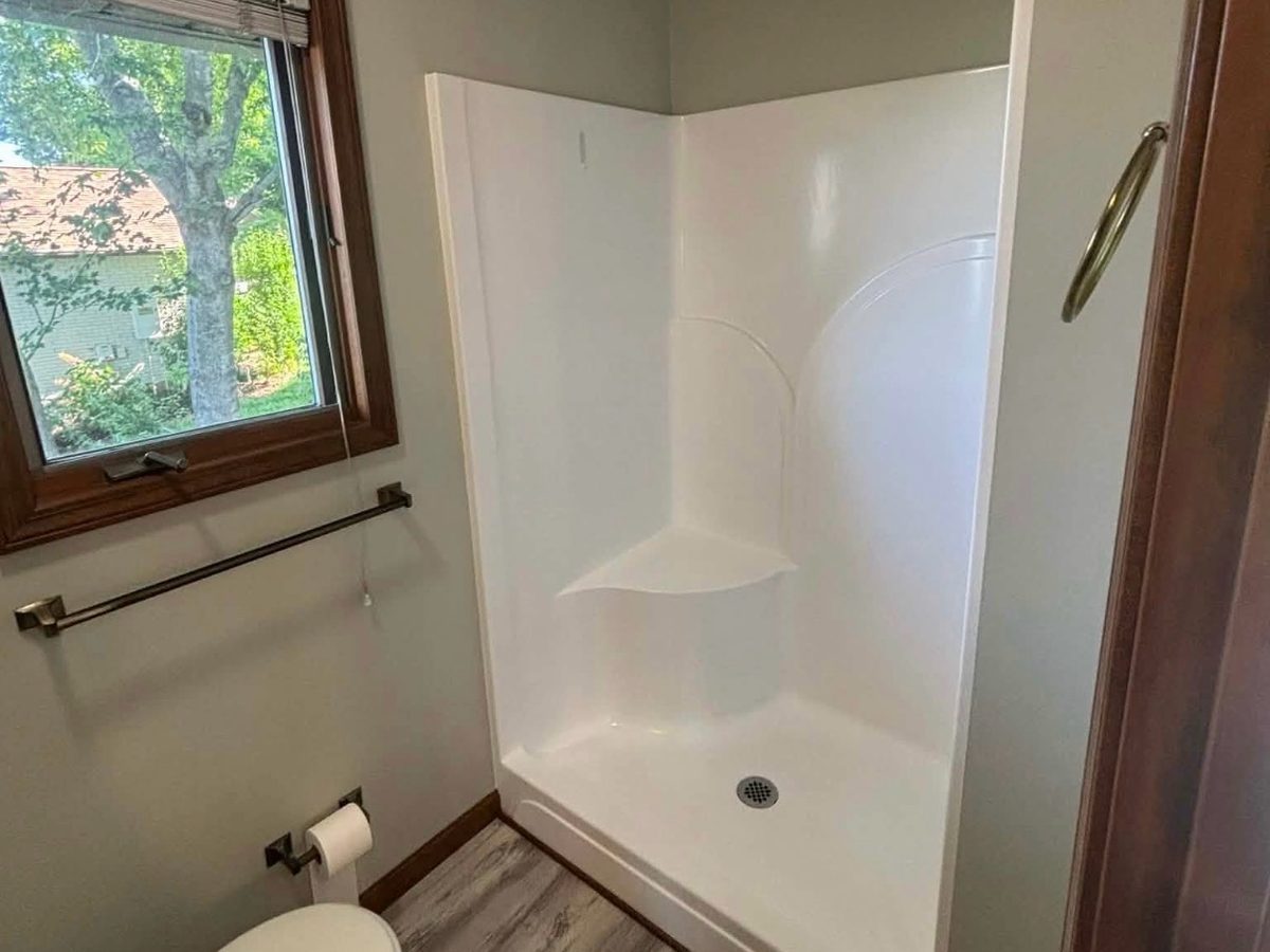 Before: a plain white fiberglass shower insert