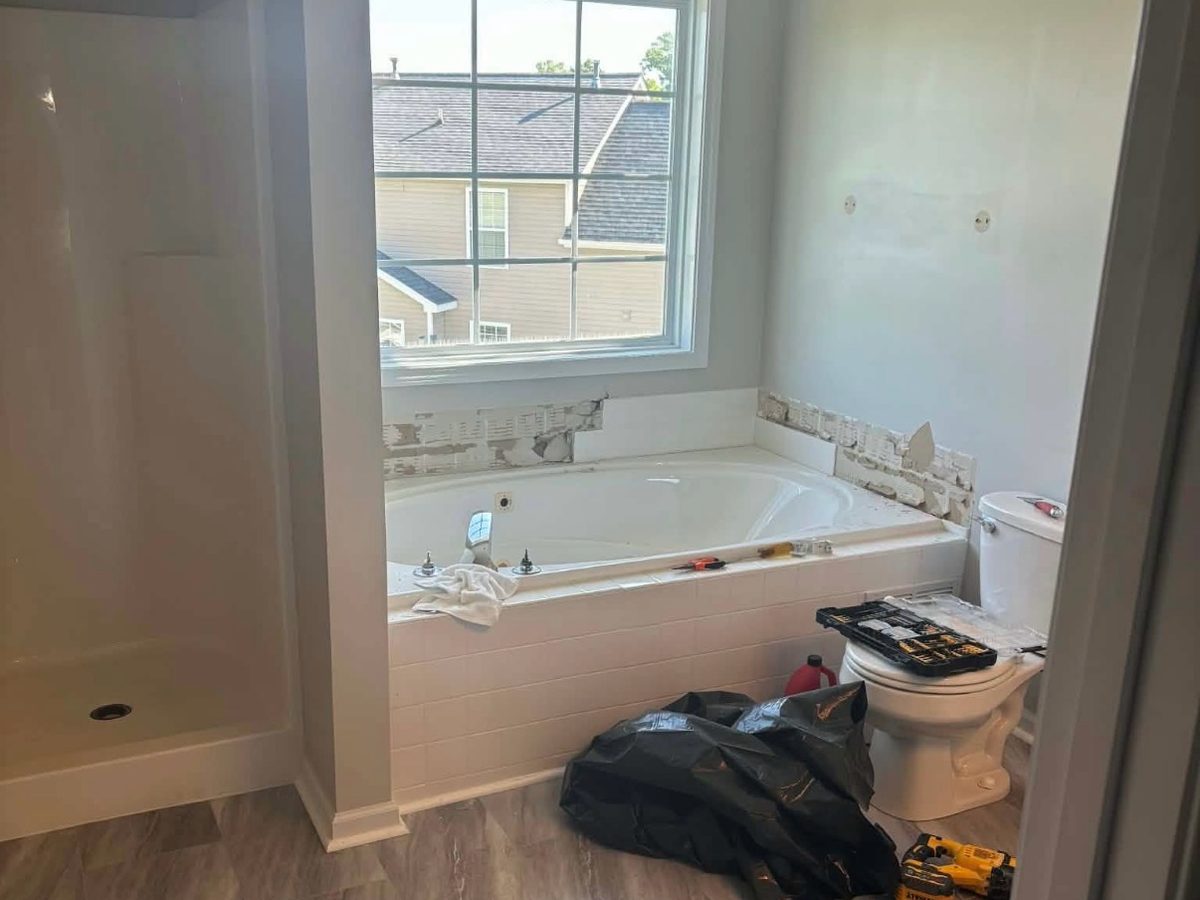 Before: a dated garden tub mid tear-out